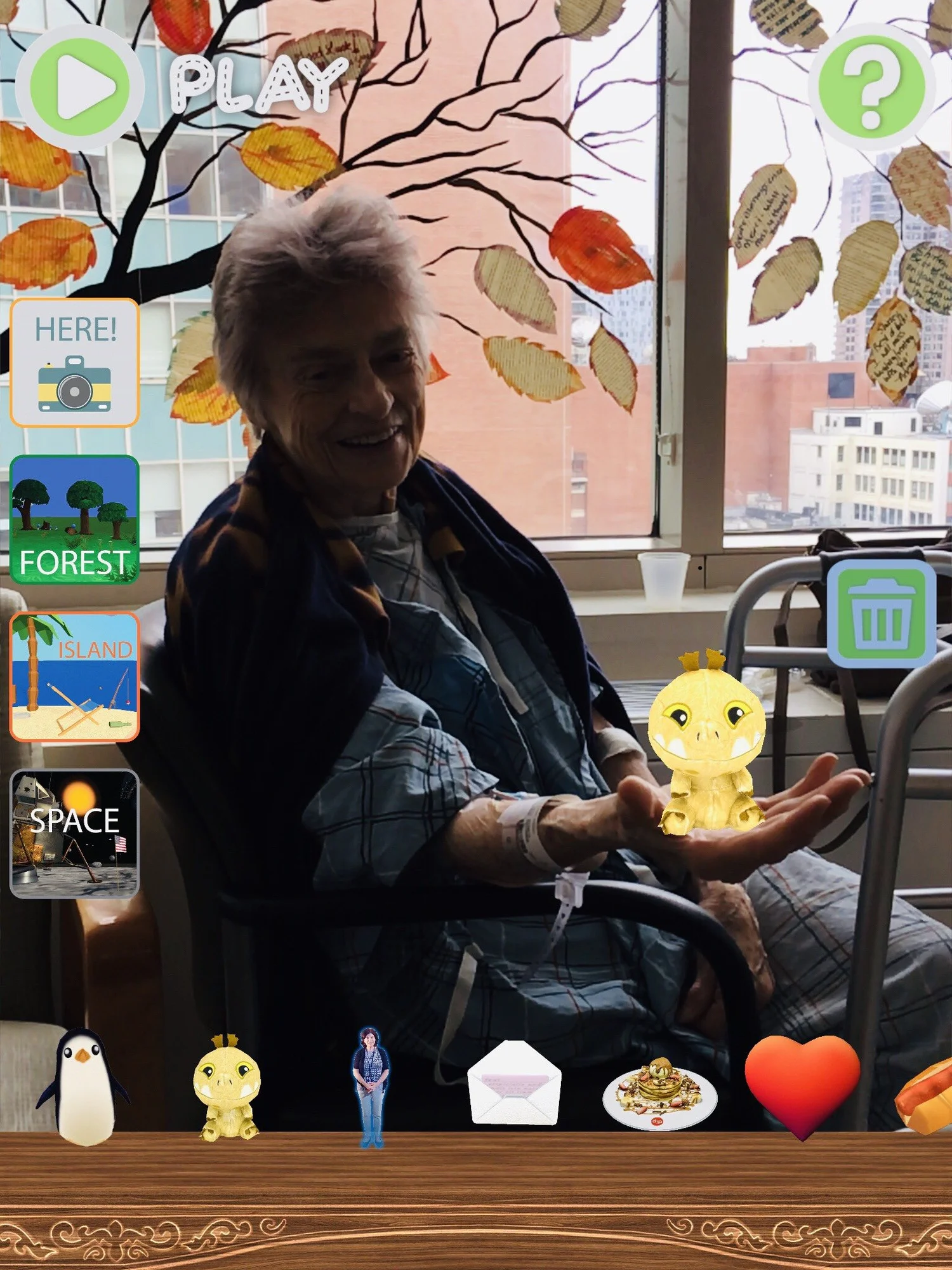 A young patient holds a glowing AR dragon in the palm of her hand